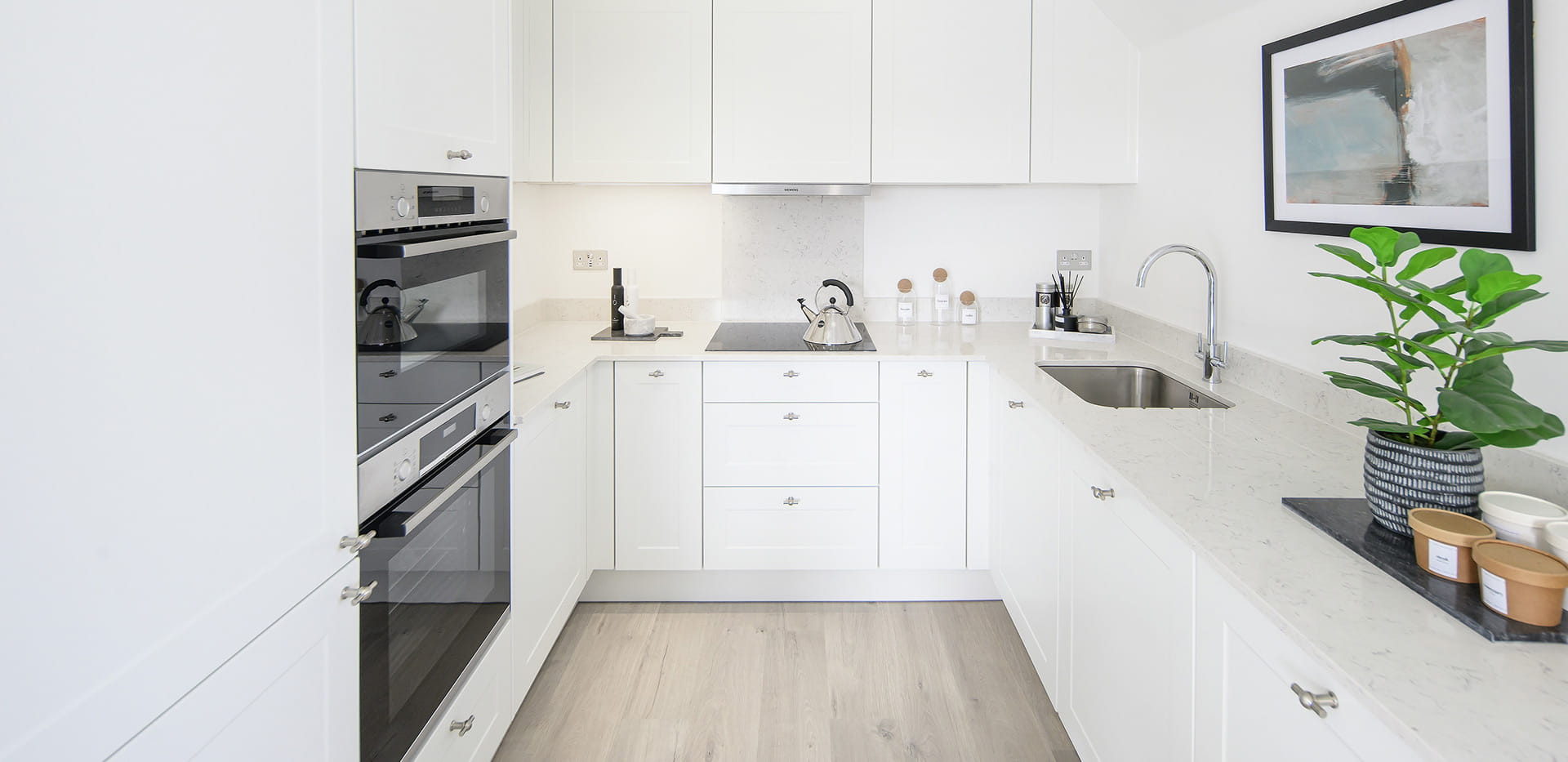 Hollyfields two bedroom apartment kitchen with a white theme