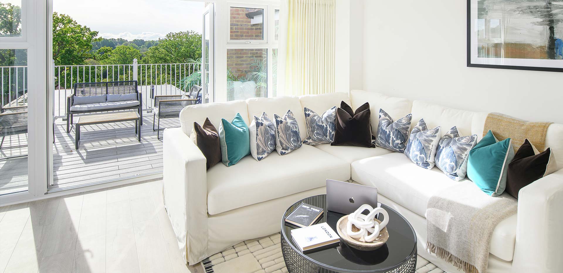 Hollyfields two bedroom apartment living area with double doors leading to the terrace