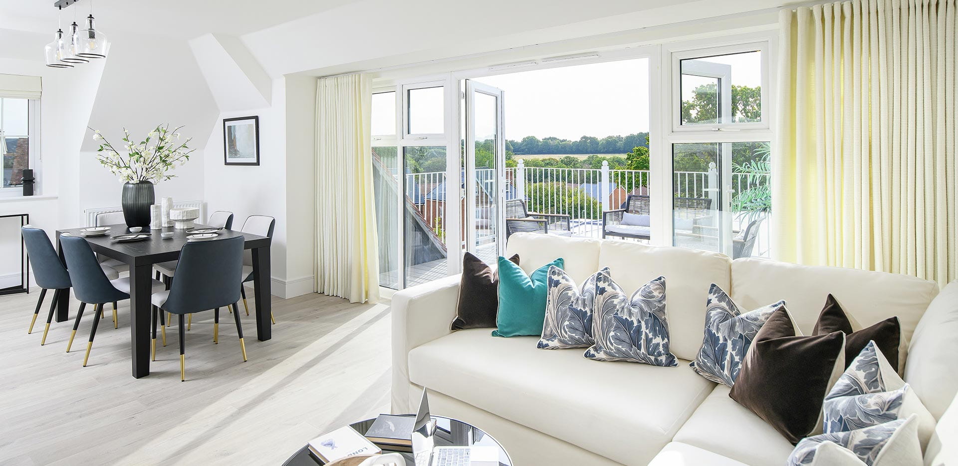 Hollyfields two bedroom apartment living and dining area with double doors leading to the terrace