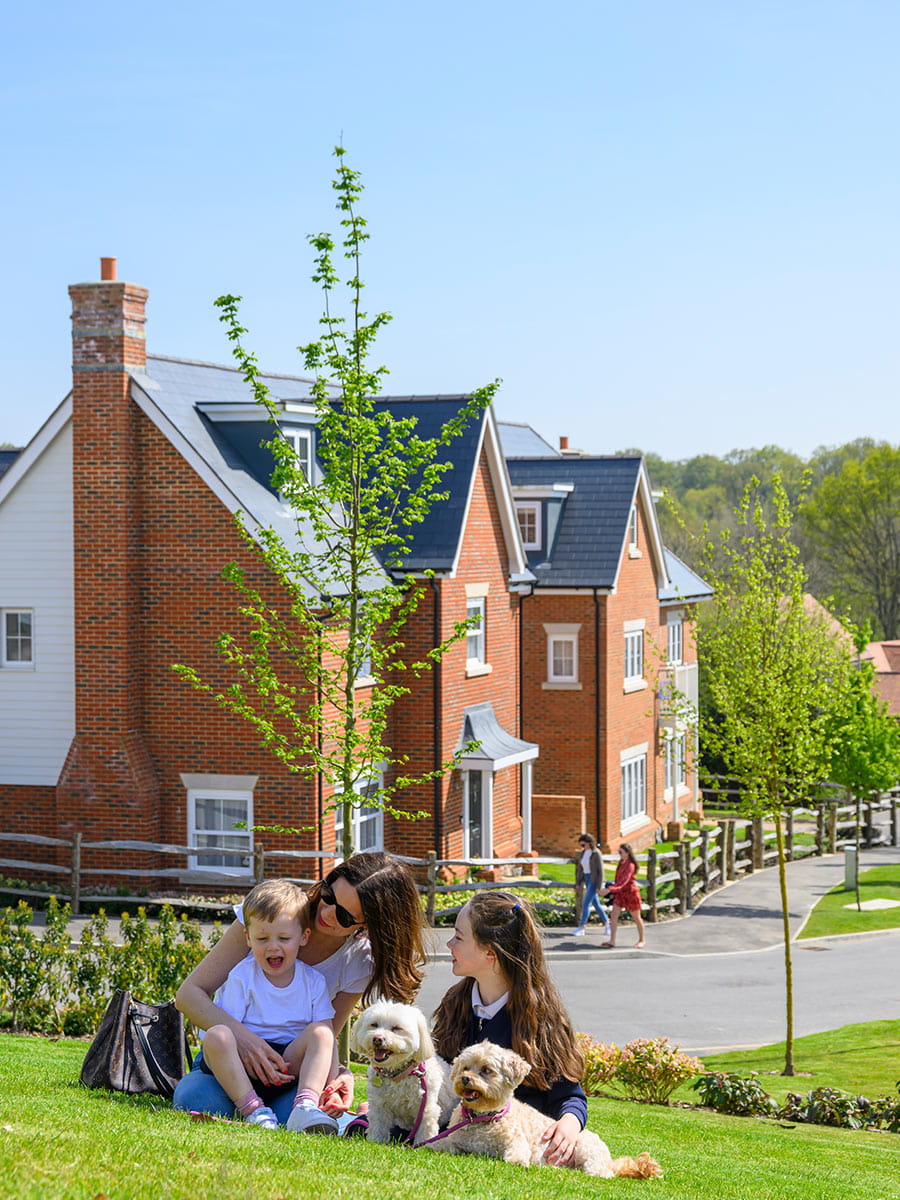 Family sitting down in Hollyfields park
