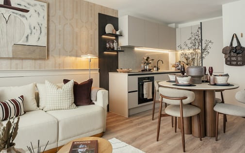 Contemporary designed living space with fabric sofa, coffee table, dining table and kitchen space