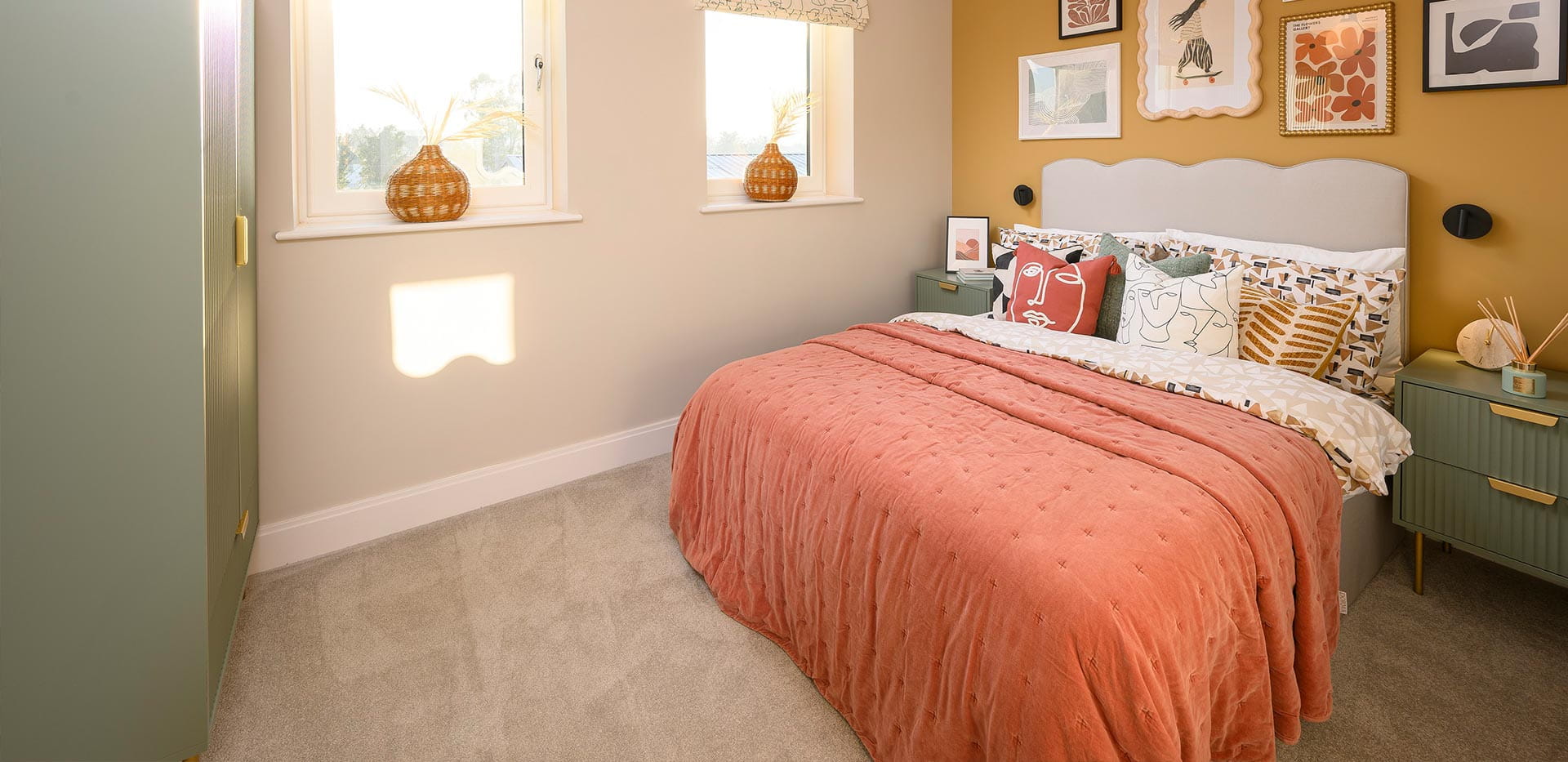An interior Bedroom image with a yellow feature wall at the Urban Houses at Horlicks Quarter