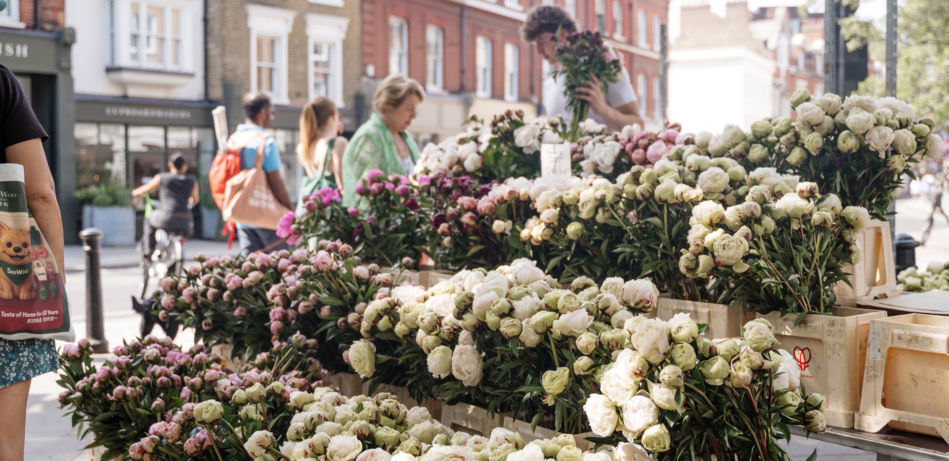 CGI of a streetside florist stall with a front display of bright flowers