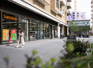 A view of a parade of shops, including a Sainsbury's supermarket