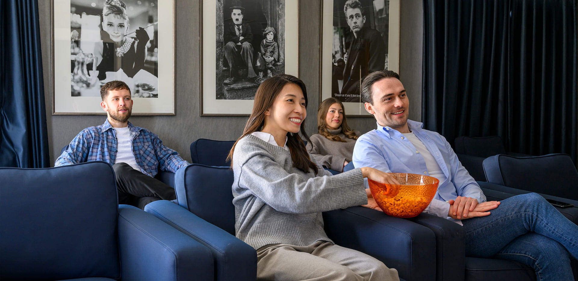 An image of residents at Kidbrooke Village enjoying the residents' facilities, using the Cinema Room.