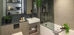 Bathroom with dark themed interior and black, grey and gold finishings 
