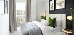 Neutrally coloured bedroom with large, centred, bed and textured black wall