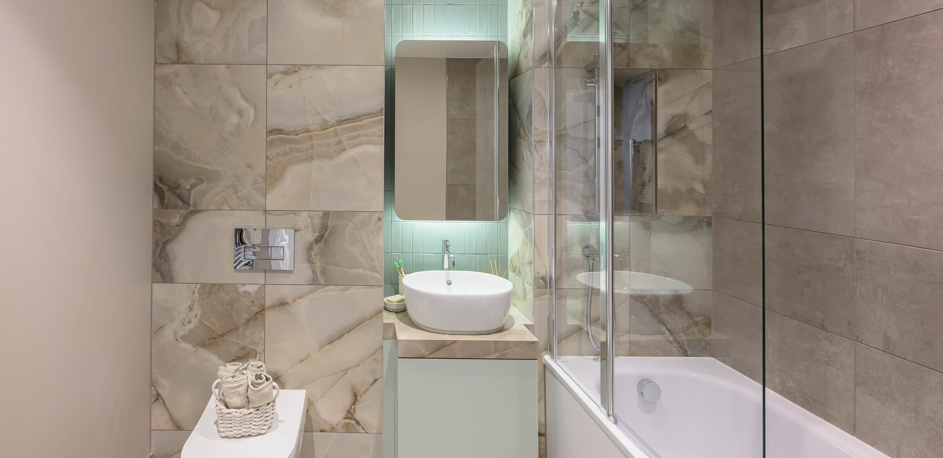 shower over bath, wash basin with cabinet mirror, toilet.