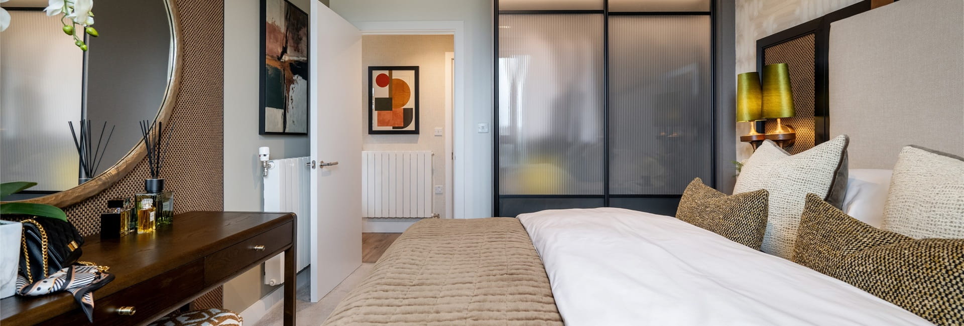 Modern designed bedroom with vanity table, bedside tables, built-in wardrobe.