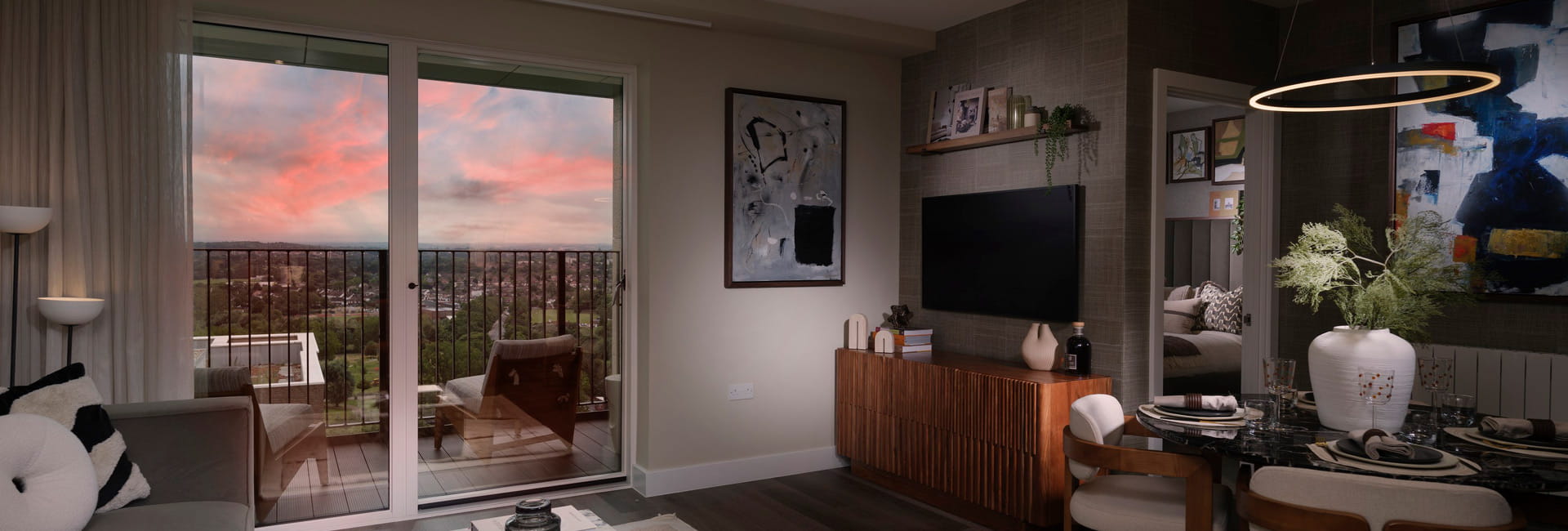 Modern designed living space with sofa and coffee table adjacent to balcony doors.