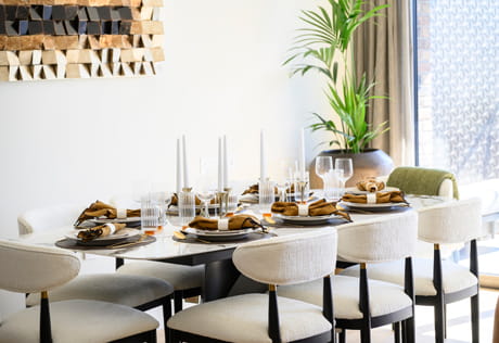Dining table. white and black design palette, ample natural lighting from adjacent window