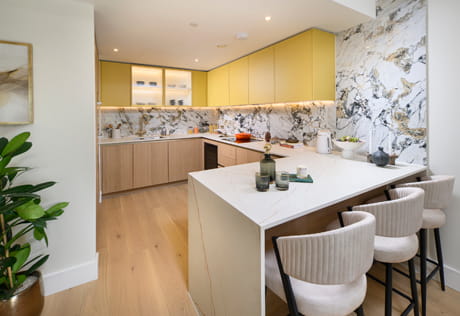 Breakfast island in foreground, kitchen in background