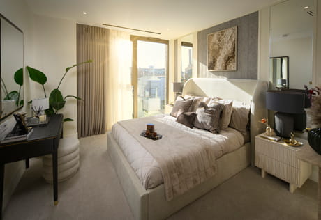 Bedroom in white, black and beige colour tones, wall hanging, bedside tables