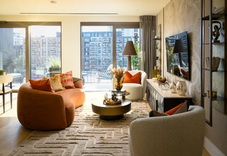 Living space, modern designed seating and coffee table, ample natural lighting from high windows