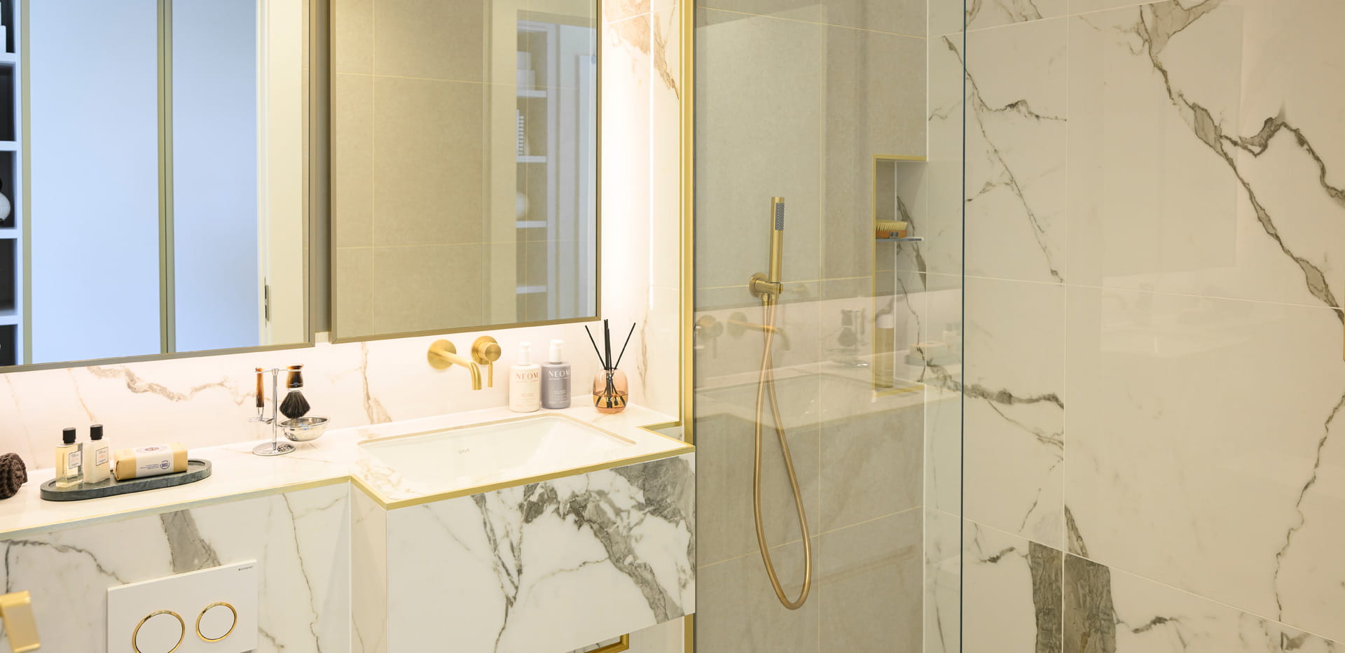 Modern designed bathroom with shower unit, wash basin with wall mirror, toilet and cabinet space