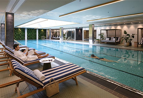 Swimming pool, with sun chairs laid out poolside