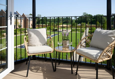 Balcony view of outdoor furniture, overlooking central private garden.