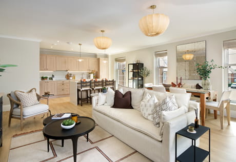 Contemporary designed living space dining area with kitchen and breakfast island in background.