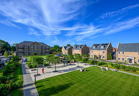 An exterior image of homes and the green space available at Leighwood Fields