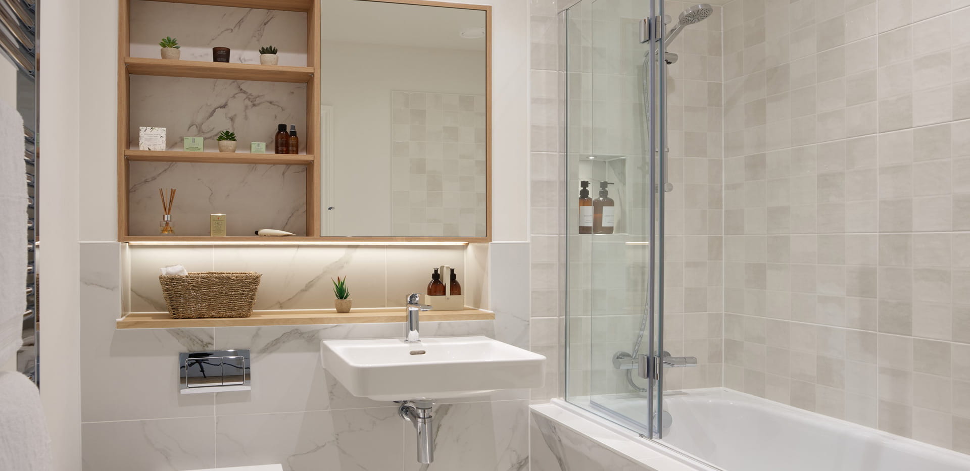 Bathroom with shower over bath, wash basin with cabinet mirror and shelving.