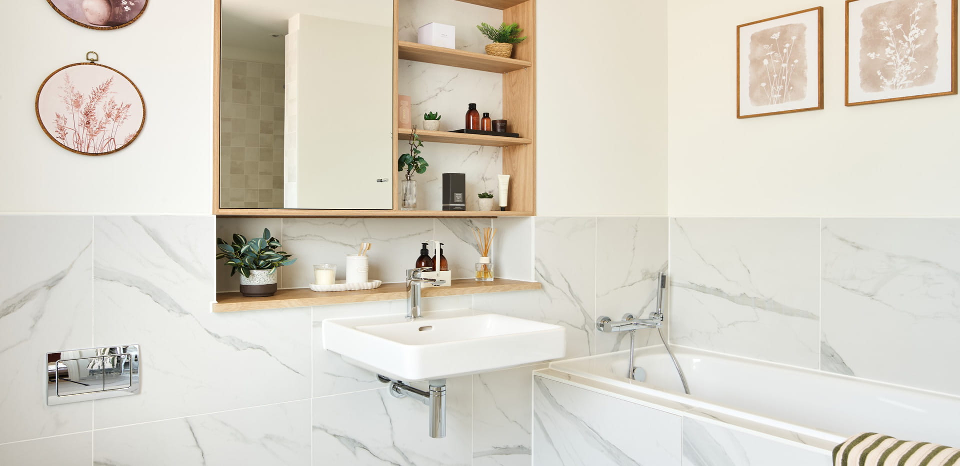 Bath, wash basin with mirror and shelving.