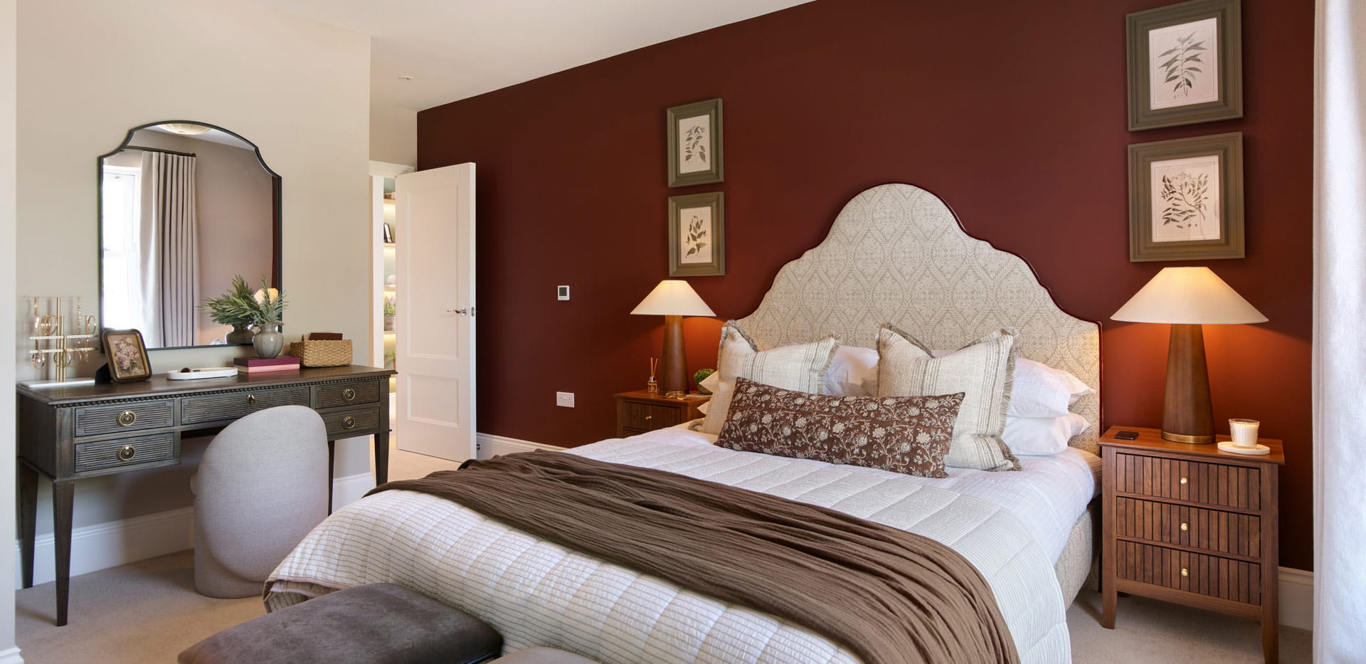 Double bed with contemporary design, bedside tables and wall hanging, vanity table.