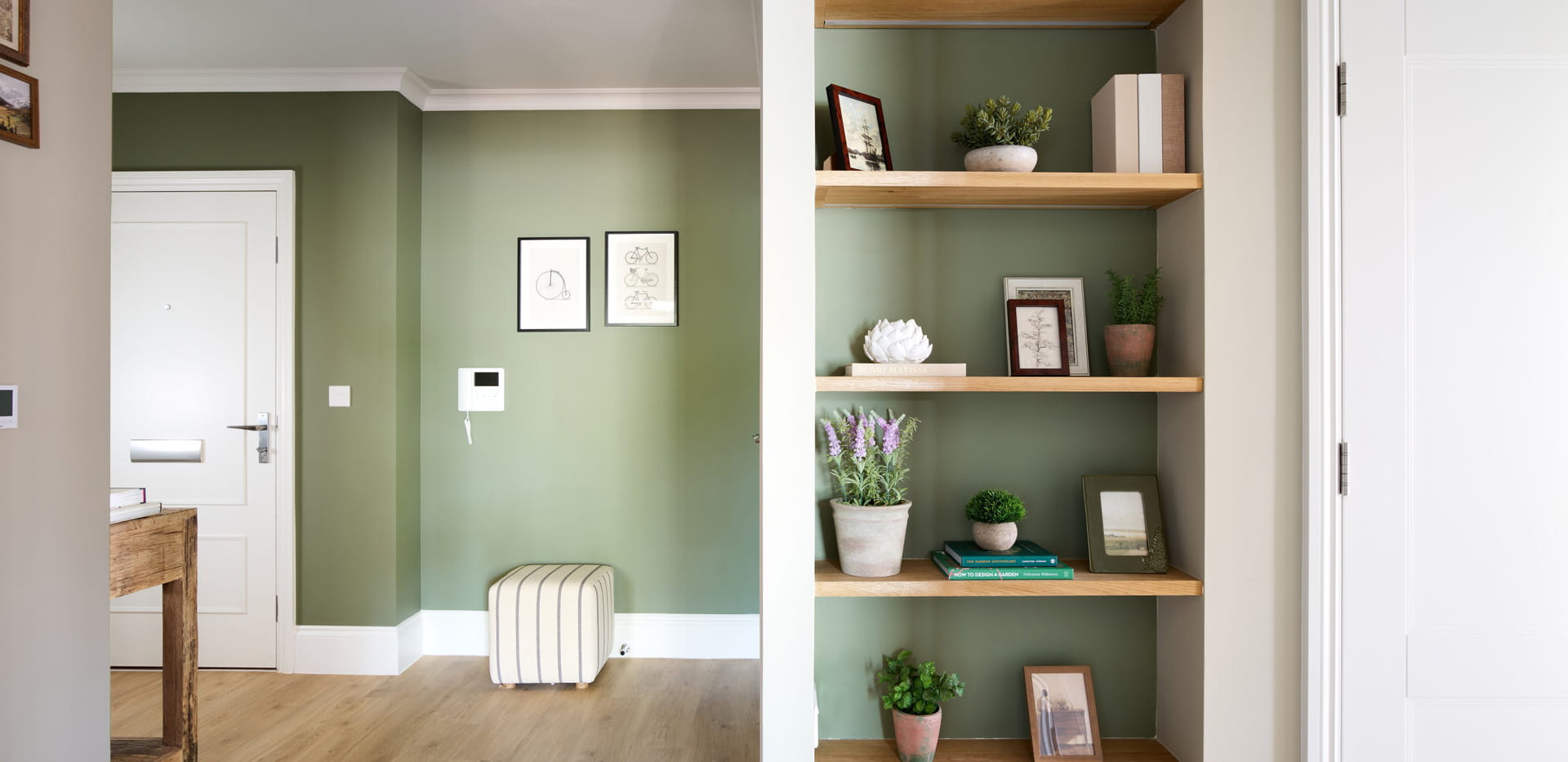 Closeup of hallway, shelves built in, light green wallpaper.
