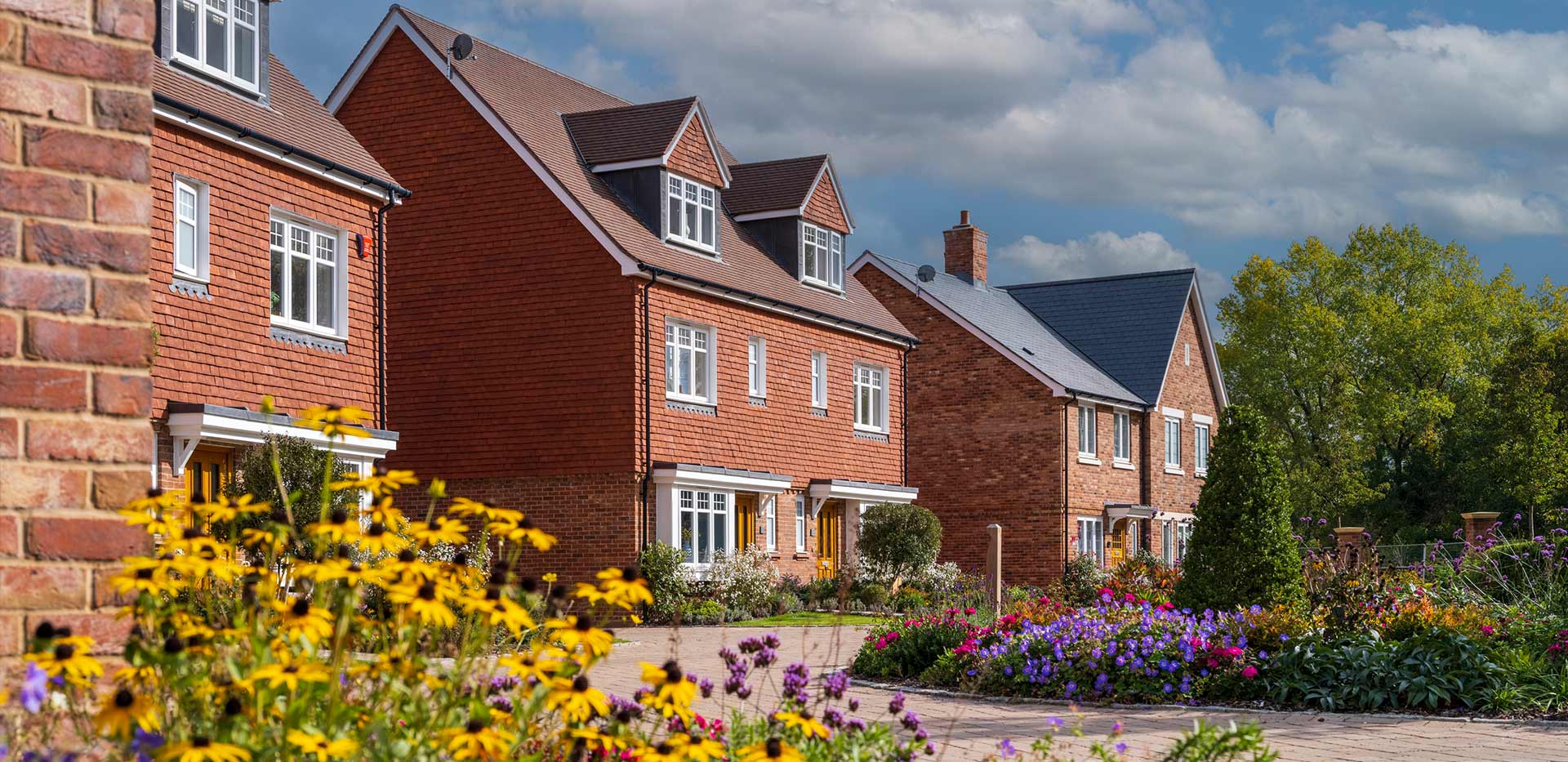 An exterior street scene with colourful flowers around