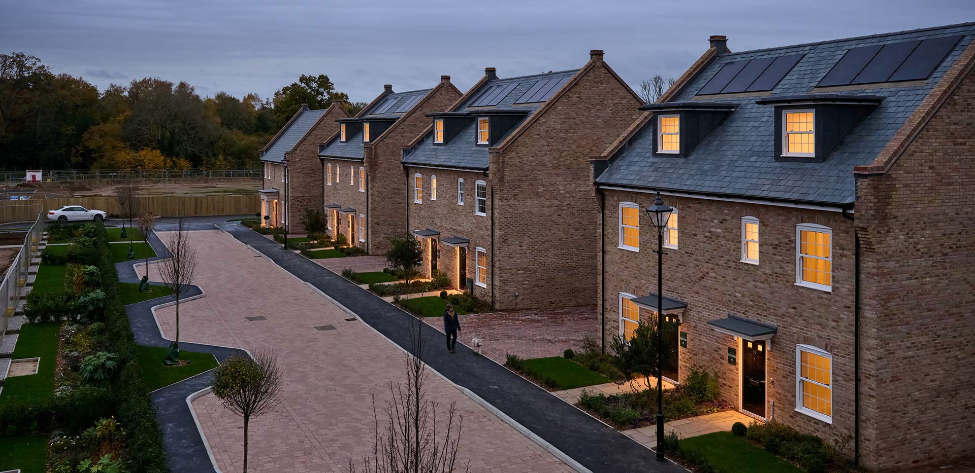An exterior street scene at dusk at Leighwood Fields
