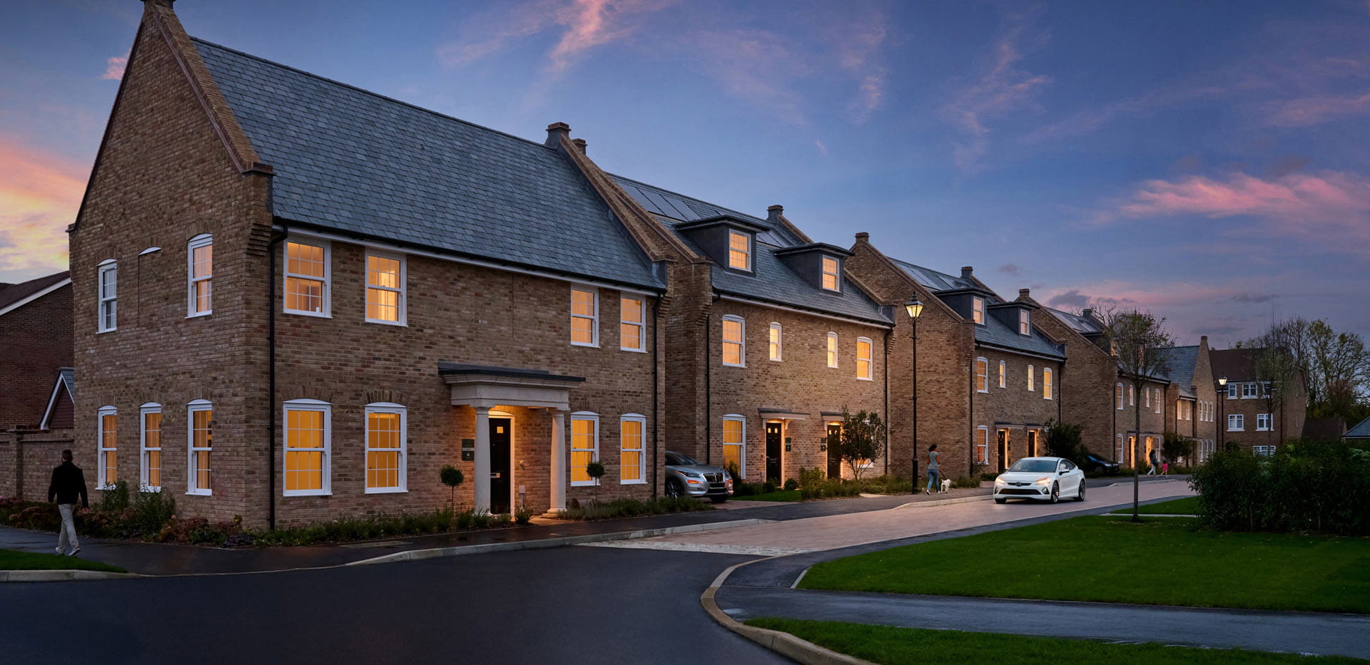CGI of external development housing facades, front drives and private road.