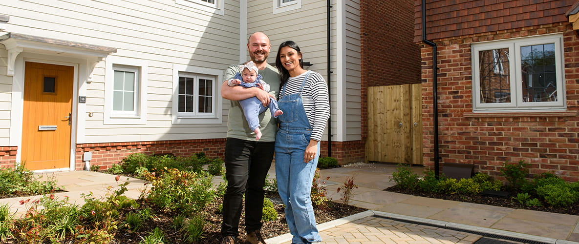 A family posing for a photo outside their new Berkeley home