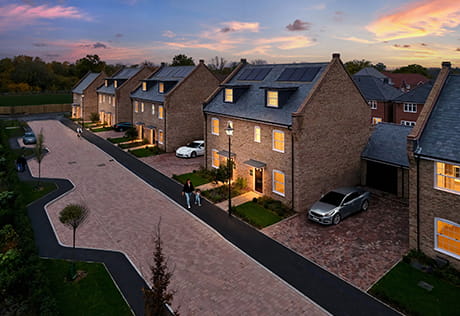 An image of new build houses at Leighwood Fields with colourful flowers and vast green garden space