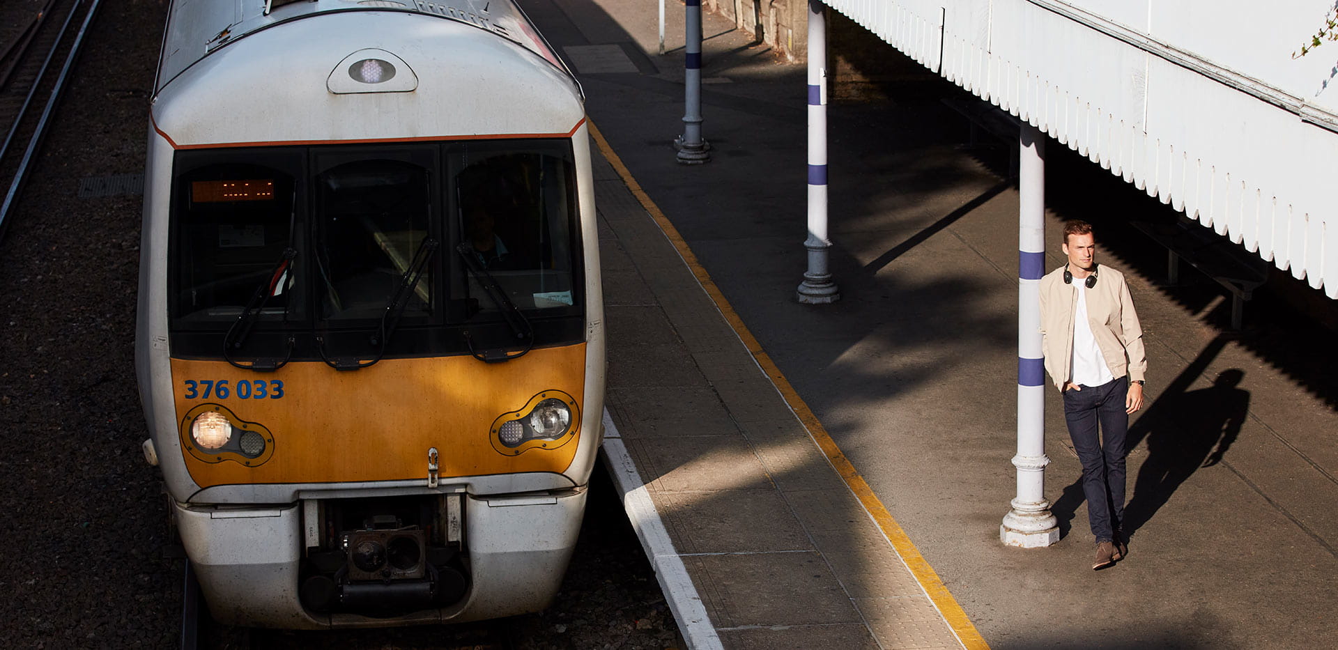 Photography of a person waiting at a train station