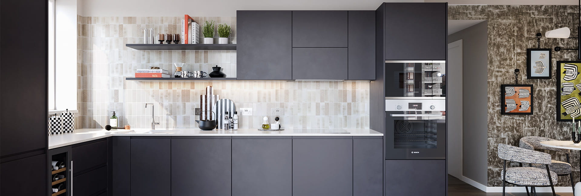 Modern kitchen with dark grey cabinets, white worktop, tiled splashback and built-in oven beside a dining nook.