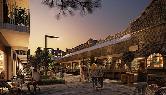 Image of residents walking by the development at night