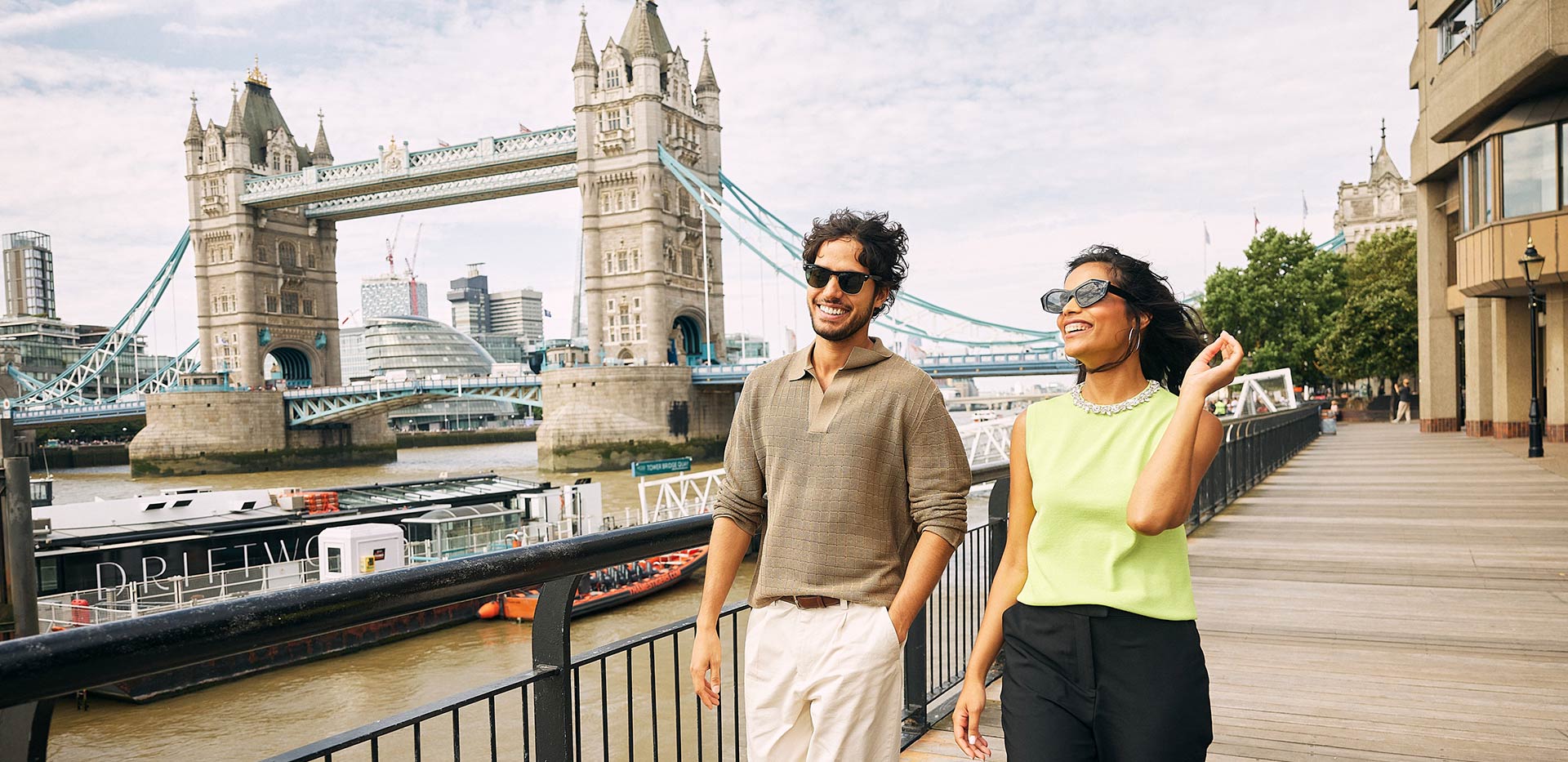 An image of residents walking down the Thames with the Tower of London in view