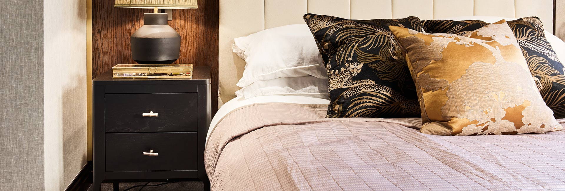 A close up image of the bed and side table at London Dock