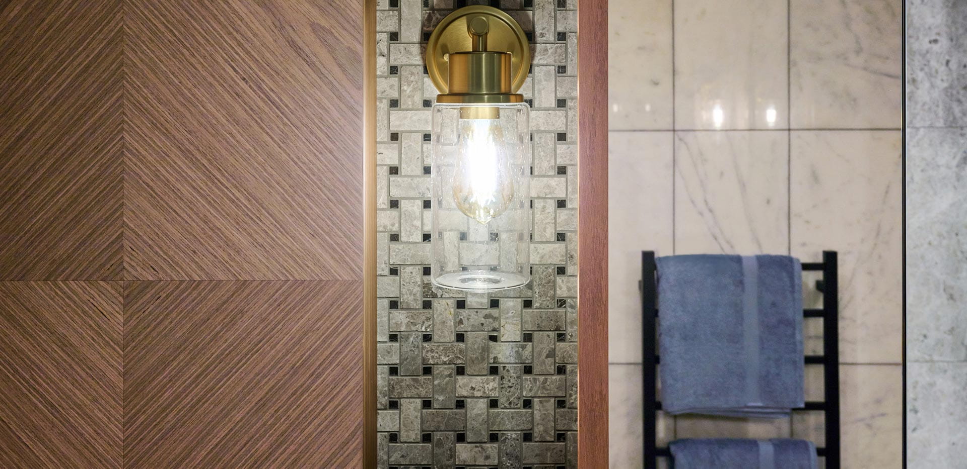 An image of a light on the wall leading into the bathroom