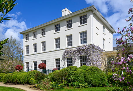An exterior photograph of white building at Oakhill