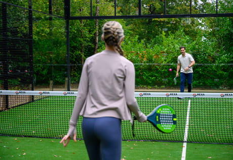 Man and women playing padelboard