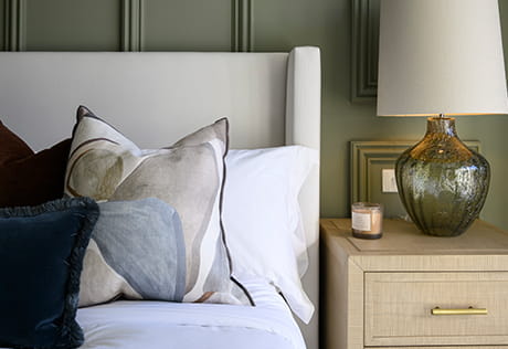 A close up image of a bed from a showhome at Oakhill