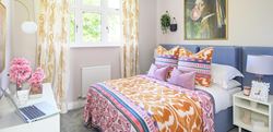 Double bedroom with vibrant pink and purple design