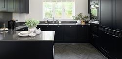 Dark design kitchen with black decor and grey flooring