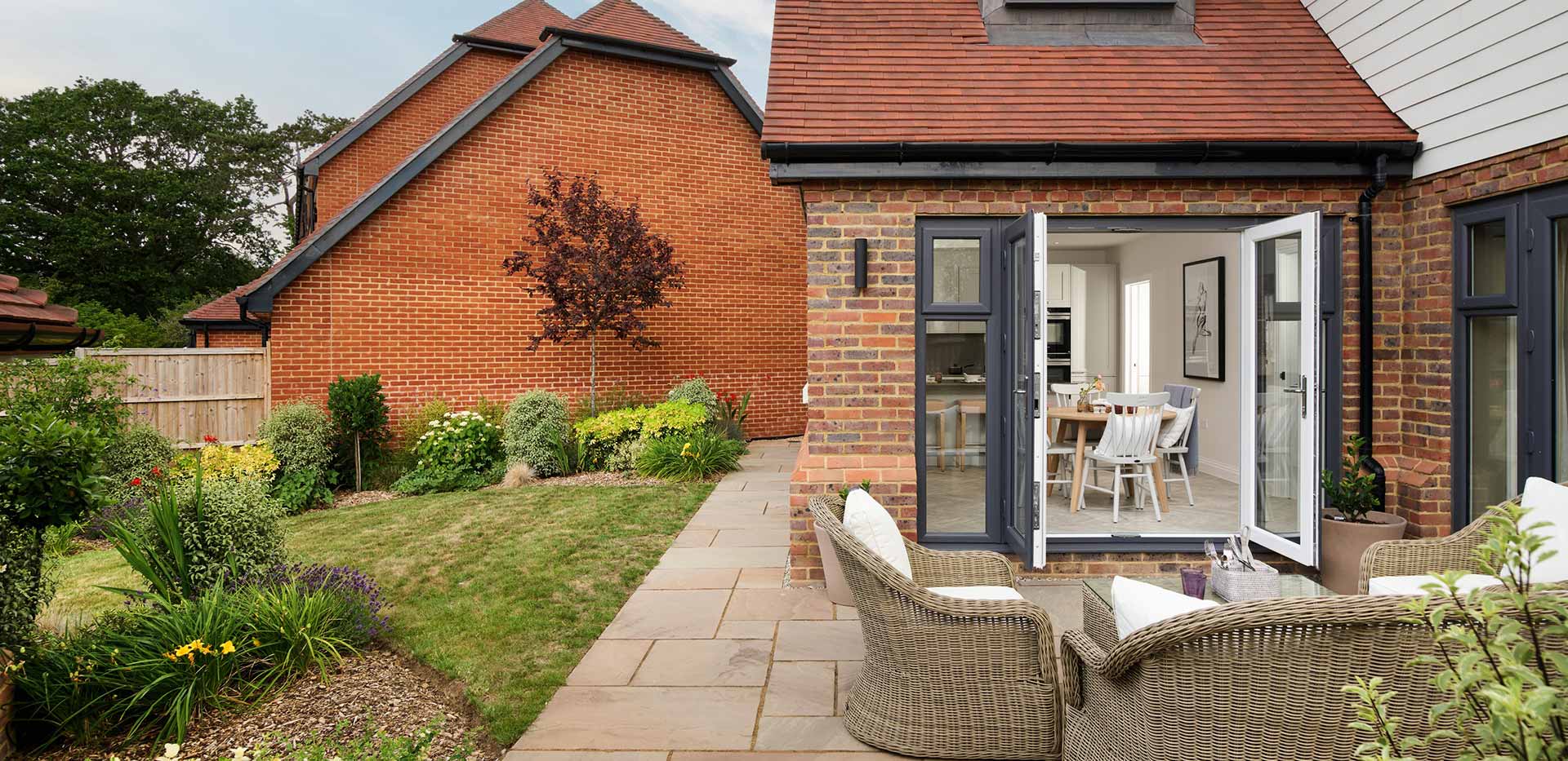An image of the Garden and Patio looking at the Kitchen dining area at Oakhill Copse