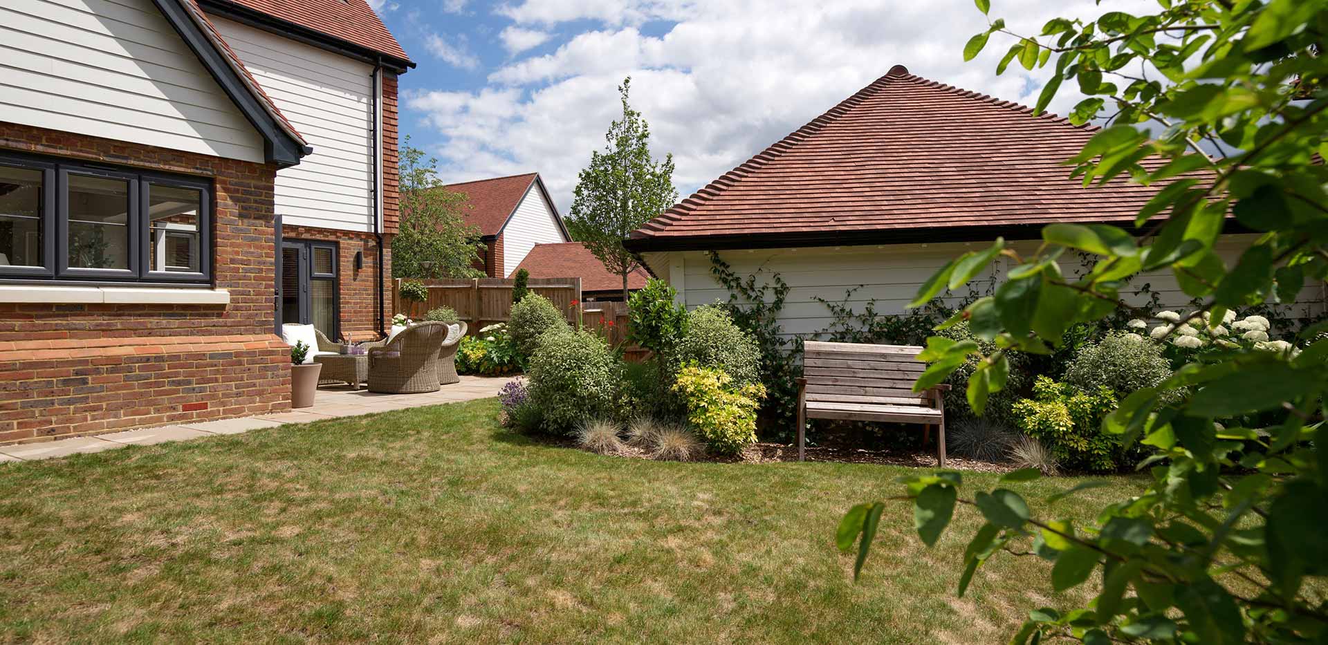 An image of the Garden showing the patio and grass at Oakhill Copse