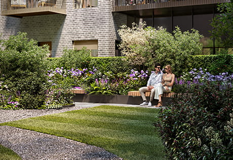 Couple sitting in the residents grounds at Oval Village