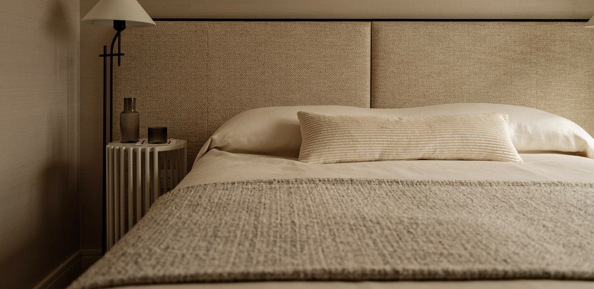 A close up image of a bed from Oval Village