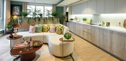 The Pinnacle show apartment living area with a central U-shaped sofa and vibrant decor
