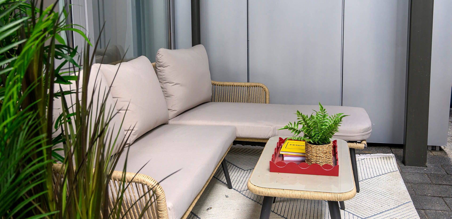 An image of the seating area with a balcony of a Berkeley development