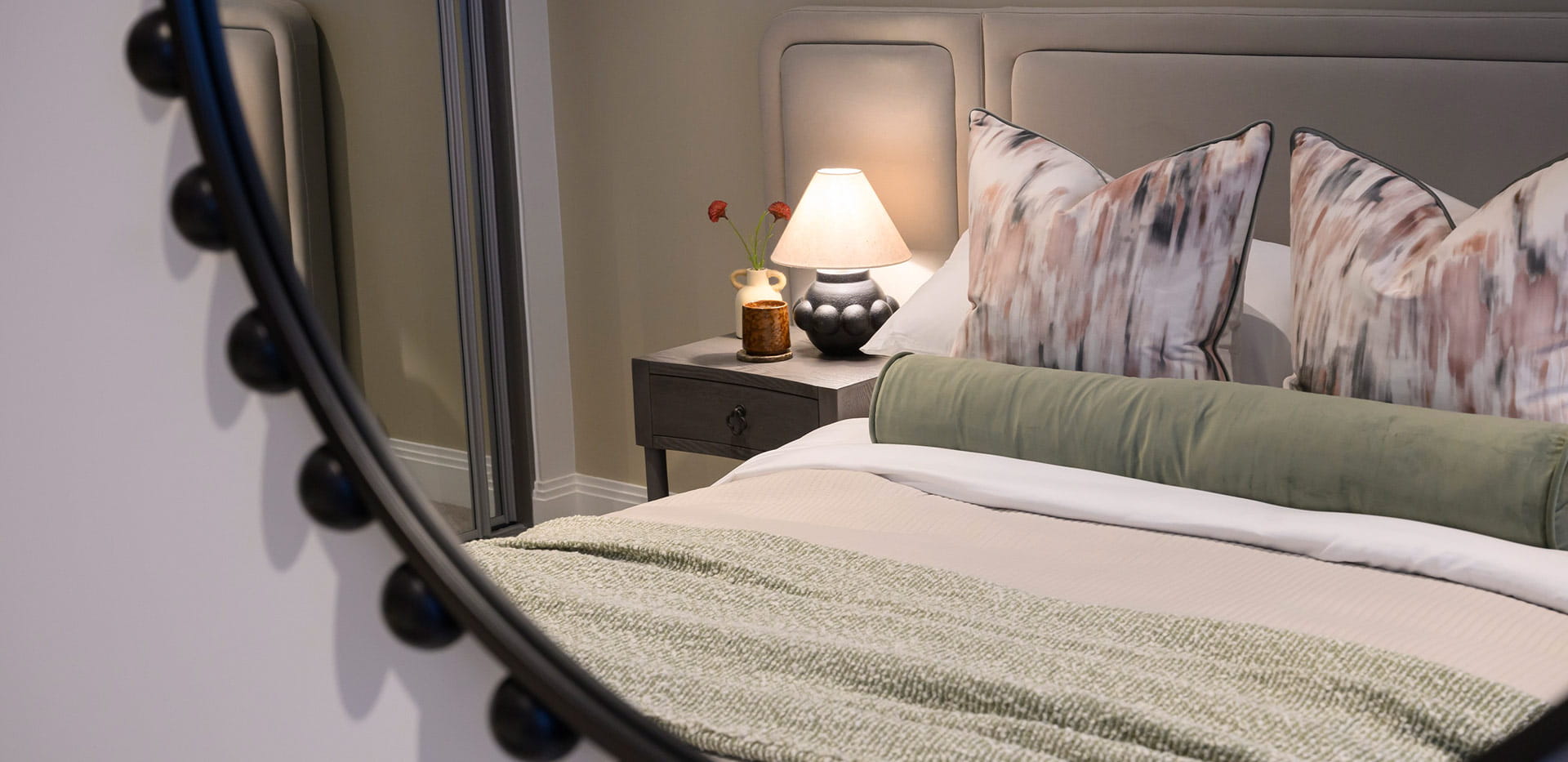 The reflection of the bedroom in a mirror on a wall